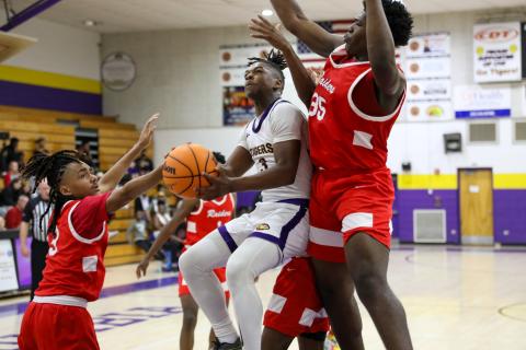 Columbia guard Zamarion Jones tries to get off a shot while being defended by Santa Fe guard Camden Mcleod (3) and forward Jamarion Foye (35) on Friday night. (BRENT KUYKENDALL/Lake City Reporter)