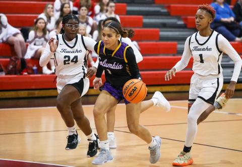 Columbia guard Mariah Cox pushes the ball up the floor in transition as Fort White guard Nahiemah Ottinot gives chase on Tuesday night. (BRENT KUYKENDALL/Lake City Reporter)