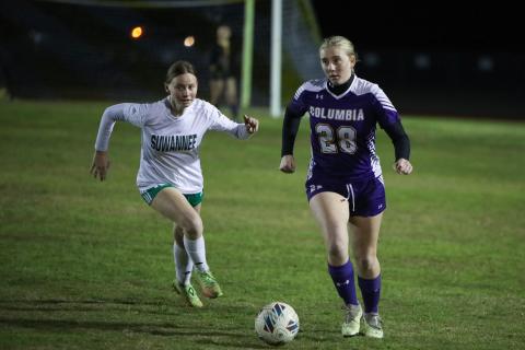 Columbia's Kyndall Norris dribbles up the field as Suwannee's Whitton Musgore gives chase on Thursday night. (BRENT KUYKENDALL/Lake City Reporter)