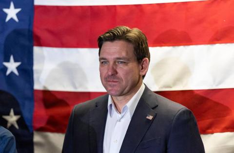Florida Gov. Ron DeSantis listens during a rally at the Never Back Down super PAC headquarters on Saturday in West Des Moines, Iowa. (MATIAS OCNER/Miami Herald/TNS)