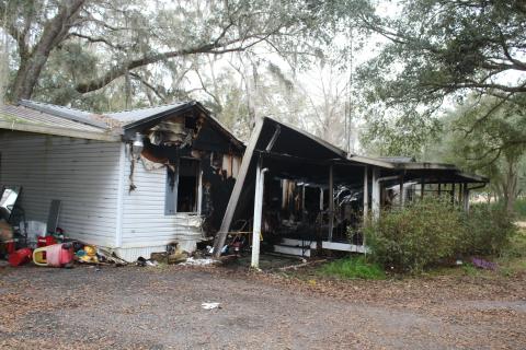 Columbia County firefighters pulled a woman and her two dogs from a mobile home fire on King Street on Tuesday morning. The woman was airlifted to an area hospital. (TONY BRITT/Lake City Reporter)