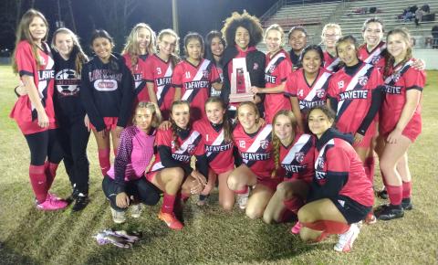 Lafayette's girls soccer team celebrates with the District 2-2A trophy after defeating Trenton on Tuesday night. (CONCEPCION LEDEZMA/Special to the Reporter)