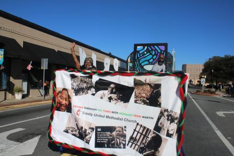 Pamela Green, the pastor at Trinity United Methodist Church, waves from the church’s entry in last year’s Martin Luther King Jr. Day parade. (FILE)