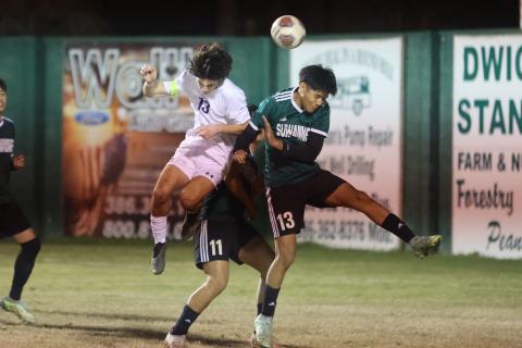 Columbia's Bergen Cobb and Suwannee's Angel Pena jump for a header during Monday night's match. (PAUL BUCHANAN/Special to the Reporter)