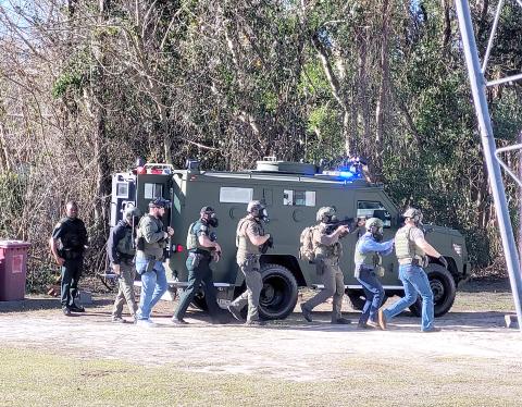 Members of the Columbia County Sheriff’s Office SWAT team gather near the camper Wednesday morning. (COURTESY COLUMBIA COUNTY SHERIFF’S OFFICE)