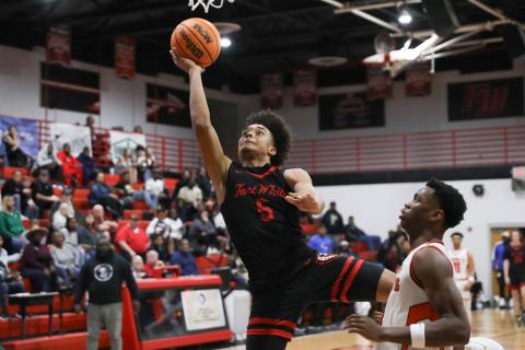 Fort White guard Tafari Moe rises for a shot while defended by Hawthorne guard CJ Ingram during the District 6-1A semifinals on Feb. 8. (BRENT KUYKENDALL/Lake City Reporter)