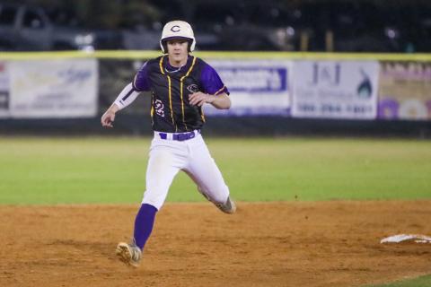 Columbia outfielder Branson Mann turns off second base toward third during Tuesday's season opener against North Marion. (BRENT KUYKENDALL/Lake City Reporter)
