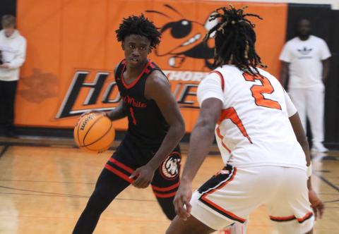 Fort White guard Jayden Jackson sizes up Hawthorne's Caleb Rollerson in the first half of Thursday's Region 3-1A semifinal. (MORGAN MCMULLEN/Lake City Reporter)