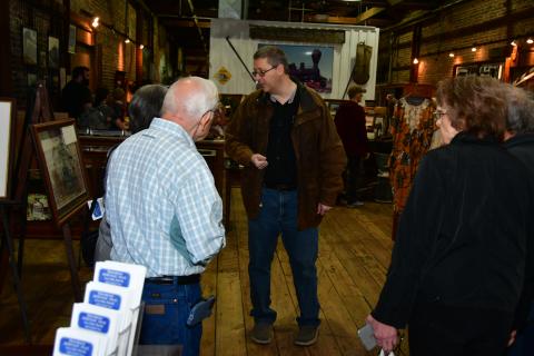 Suwannee County Historian Eric Musgrove (center) gives a tour of the Suwannee County Historical Museum during the All Aboard Festival in Heritage Square on Saturday. (ROB WOLFE/Special to the Reporter)