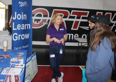Rose Jones (from left), a Florida Department of Transportation employee, talks to Jaden Klys and Angelis Owens during the Fort White High School Career Fair on Thursday at the school gymnasium. More than 40 vendors attended the session telling students about post high school education and career opportunities. (TONY BRITT/Lake City Reporter)