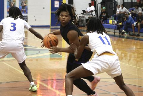 Columbia forward Jalen Gaskins looks for a lane to the basket while being defended by Rickards forward Travell Gallon during Saturday's District 2-5A championship. (MORGAN MCMULLEN/Lake City Reporter)