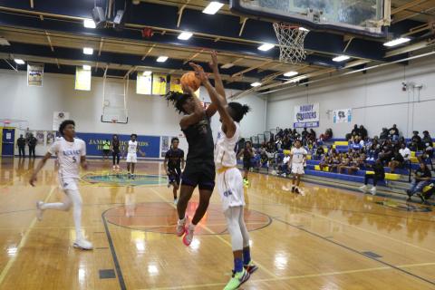 Columbia forward Justice Kelly has his shot blocked by Rickards' Travis Morris in the second half of Saturday's District 2-5A championship. (MORGAN MCMULLEN/Lake City Reporter)