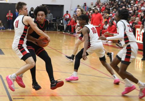Fort White guard Tafari Moe gets tied up with Hilliard’s Brandyn Seldomridge in the fourth quarter of Tuesday’s Region 3-1A championship. (MORGAN MCMULLEN/Lake City Reporter)