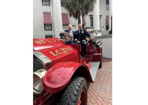 Lake City Fire Chief Josh Wehinger (right) and Florida Chief Financial Officer Jimmy Patronis are pictured atop the LCFD’s antique 1926 fire engine Thursday at the Capitol. (COURTESY)