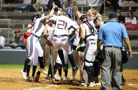 Columbia's Harleigh Price (21) is greeted at home plate after hitting a go-ahead 3-run home run against Lafayette on Thursday night. (JORDAN KROEGER/Lake City Reporter)