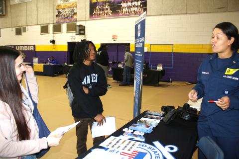Karyss Butler (from left) and Christopher Hardman, two Columbia High seniors, get recruitment and career tips from Mary Sharpelletti, Chief Petty Officer with the USCG recruiting office in Jacksonville during the Columbia High School College and Career Fair on Thursday. (TONY BRITT/Lake City Reporter)
