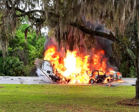 Two SUVs and a travel trailer burst into flames Friday evening on State Road 136 near the State Farmer’s Market in White Springs. A Lake City man was killed in the crash. (GLENN ALLEN/Special to the Reporter)