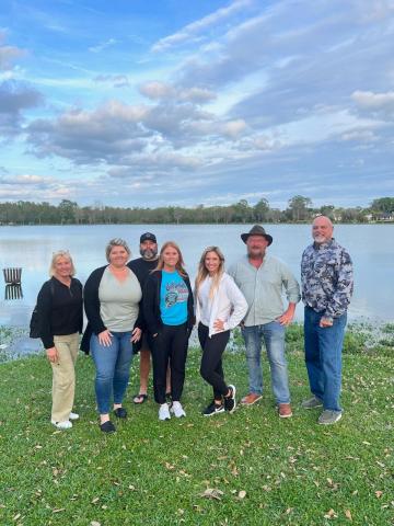 DeSoto Derby Canoe Race committee members Dana Solenski (from left), Brandy Meeks, Troy Markham, Lindsey Markham, Rosy Sparks, Chris Samson and Jerry Solenski, stand on the banks of Lake DeSoto. Elks Lodge #893 is hosting a canoe race this weekend on the lake as a fundraiser. (COURTESY)