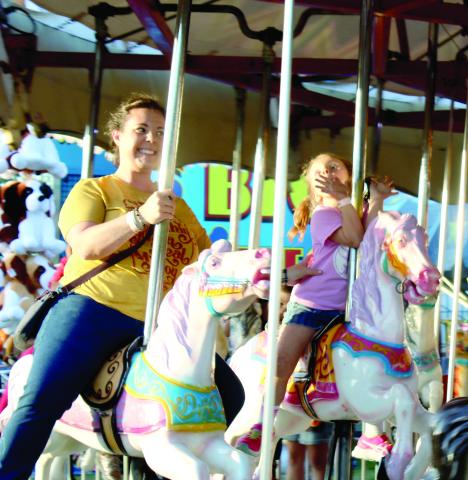 A mother and daughter enjoy a ride at a previous year’s Suwannee County Fair. The 109th annual fair begins its nine-day run Friday at the Suwannee County Fairgrounds. (FILE)
