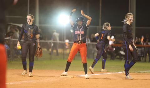 Fort White’s Jermauni Byrd celebrates on third base between Branford shortstop Cloey Criggall and third baseman Madyson Sikes on Friday. (PAUL BUCHANAN/Special to the City Reporter)