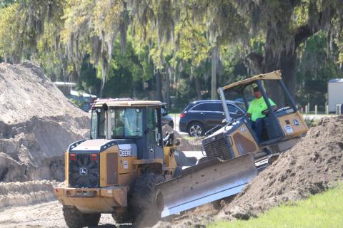 A pair of workers for Charles Peeler Construction move dirt at the site of a future Tractor Supply Co. store on East Duval Street in Lake City. Crews are currently getting the site ready for building construction. (TONY BRITT/Lake City Reporter)
