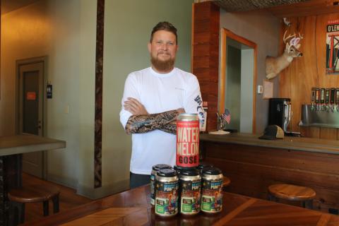 Jonny Frazier, Halpatter Brewing Company head brewer and co-owner, stands with the brewery’s Watermelon Gose and Blue Raspberry Lemonade Punch Out, two of its award-winning brews in the Untappd Community Awards. (TONY BRITT/Lake City Reporter)