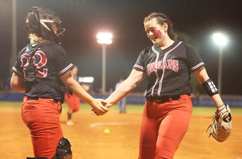 Fort White catcher Chloe Kirby (left) shakes hands with pitcher Kadence Compton (right) after the final out of the Indians’ win over Branford on March 1. (PAUL BUCHANAN/Special to the Reporter)