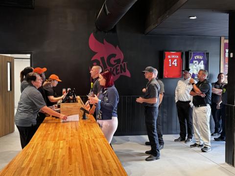 A line of first responders wait to order at Big Chicken during Tuesday’s sneak peek at the new Lake City restaurant. (JAMIE WACHTER/Lake City Reporter)