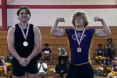 Columbia lifters Tyson Yaxley (left) and Garrett Shipley (right) celebrate on the podium after placing first and second at the District 3-2A meet on Thursday. (COURTESY)