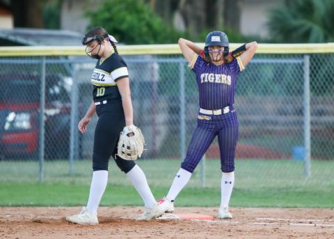 Columbia shortstop Lillyenne Mayhew smiles at first base after reaching on a single against Buchholz on Thursday. (BRENT KUYKENDALL/Lake City Reporter)