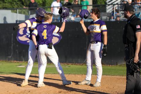 Columbia's Tryace McKenzie is greeted at home plate by teammates Max Schuler (left) and Ayden Phillips after hitting a home run against Bishop Kenny on Friday. (BRENT KUYKENDALL/Lake City Reporter)