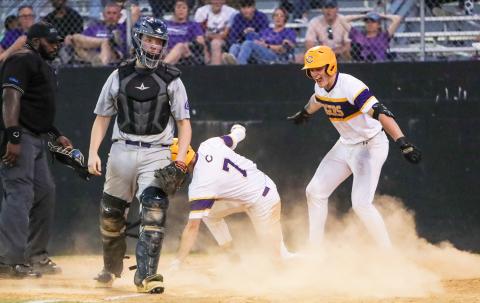 Columbia right fielder Max Schuler (right) celebrates as center fielder Bynton Edge (7) slides safely into home plate for an inside the park home run against Gainesville during Tuesday’s District 2-5A semifinal. (BRENT KUYKENDALL/Lake City Reporter)
