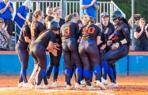 Teammates surround Mallory Blue after the Branford first baseman homered during Monday's District 6-1A quarterfinals against Lafayette. (JACK HOWDESHELL/Special to the Reporter)