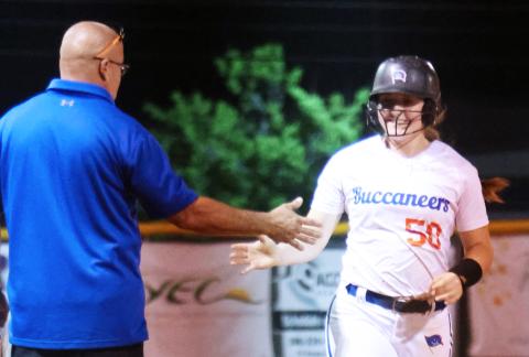 Branford's Ellie Frierson high fives head coach Oscar Saavedra as she rounds third base after hitting a home run against Suwannee on Tuesday. (PAUL BUCHANAN/Special to the Reporter)
