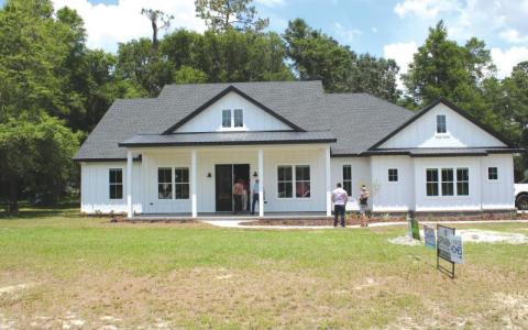 Folks wait to take a tour of one of the houses on the 2022 Parade of Homes route. (FILE)