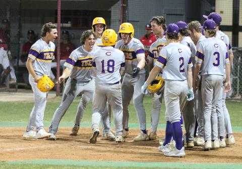 Columbia catcher Casen Maddox is greeted at home plate after hitting a go-ahead grand slam against Santa Fe on Tuesday. His home run put the Tigers up 6-5 and was part of an eight-run six inning. (JORDAN KROEGER/Lake City Reporter)