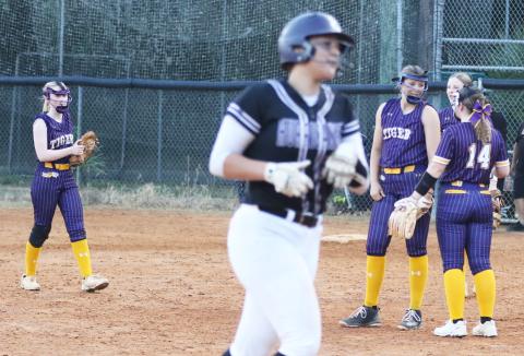 Columbia pitcher Harleigh Price gets some encouragement from teammate Alex Collins (14) as Gainesville’s Braylin Cook makes her way around the bases after a home run during Tuesday’s District 2-5A semifinal. (MORGAN MCMULLEN/Lake City Reporter)