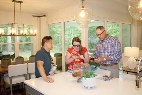 Scott Samera (from left) and Danielle Samera talk home floor plans and options with Bryan Zecher during a previous Parade of Homes event. (FILE)