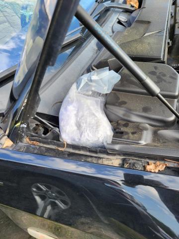Four pounds of methamphetamine were found beneath the hood of a car pulled over Wednesday on Interstate 75 for a busted windshield. (COURTESY)