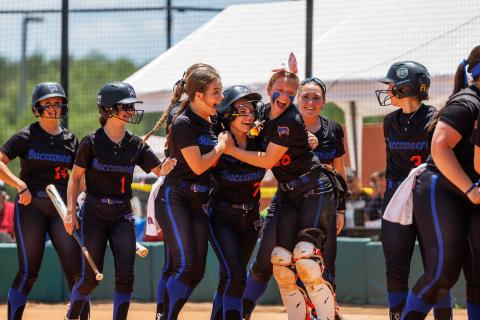 Branford outfielder Ashlee Combee (middle) is hugged by teammates Hunter Revis (left) and Morgan Brennan (right) after scoring a run against Liberty County in the Class 1A state semifinals on Friday. (JACK HOWDESHELL/Special to the Reporter)