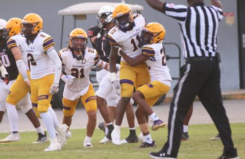 Columbia linebacker Dajon Brown celebrates with defensive backs Julian De La Cruz (21) and Mekah Combs-Turner (right) after his interception during Friday’s spring game against Fort White. (JORDAN KROEGER/Lake City Reporter)