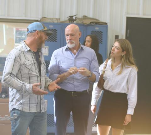 Darryl Thomas (from left), Columbia High School welding instructor, talks to Sen. Rick Scott’s team members Paul Bonicelli and Sarah Salas on Wednesday morning in the school’s welding facility. (TONY BRITT/Lake City Reporter)