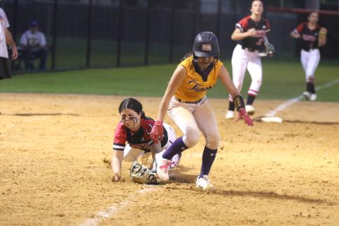 Columbia shortstop Lillyenne Mayhew gets caught in a rundown by Middleburg third baseman Madisyn Strickland in the sixth inning of Thursday's game. (MORGAN MCMULLEN/Lake City Reporter)