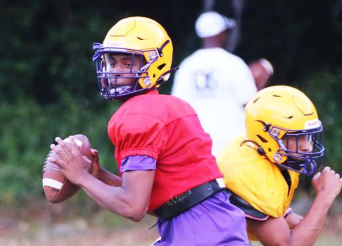 Columbia quarterback Xavier Collins drops back to pass during Wednesday’s practice. (JORDAN KROEGER/Lake City Reporter)