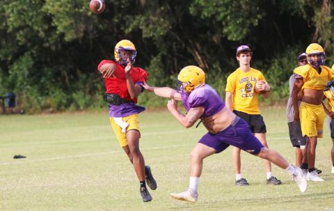 Columbia quarterback Xavier Collins throws a pass under pressure from defensive lineman Caden Bolstein during practice on May 1. (JORDAN KROEGER/Lake City Reporter)