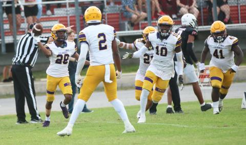 Columbia cornerback Mekah Combs-Turner (28) celebrates with teammates after intercepting a pass against Fort White during their spring game on May 17. (JORDAN KROEGER/Lake City Reporter)
