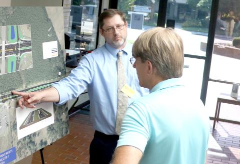 Michael Brock, an engineer with the Florida Department of Transportation, discusses the Interstate 10 and U.S. Highway 129 interchange improvements with Brent Baris during an open house Thursday at Live Oak City Hall. (MORGAN MCMULLEN/Lake City Reporter)
