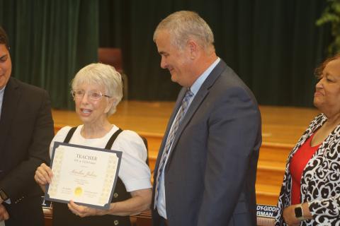 Martha Johns (from left) addresses the audience after getting her Teacher of a Lifetime certificate from Superintendent Lex Carswell on Tuesday evening. (TONY BRITT/Lake City Reporter)