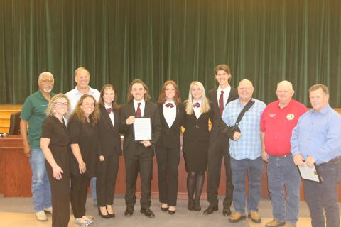 County Commissioners Ron Williams (from left) and Robby Hollingsworth stand with members and advisors for the Fort White High School HOSA parlimentarian team Christan Higginbotham, Ashley Blanton, Kamryn Cembruch, Trace Taylor, Jayda Plasencia, Clara Robinson, Kenton Hassee and Commissioners Rocky Ford, Everett Phillips and Tim Murphy. (TONY BRITT/Lake City Reporter)