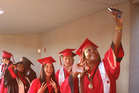 Keyonis Alexander takes a selfie with her classmates as Fort White High School graduation candidates head to the stadium for the school’s commencement exercise on Friday night. (TONY BRITT/Lake City Reporter)